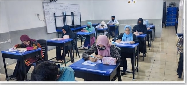 ELS students sitting an in-person written exam at desks